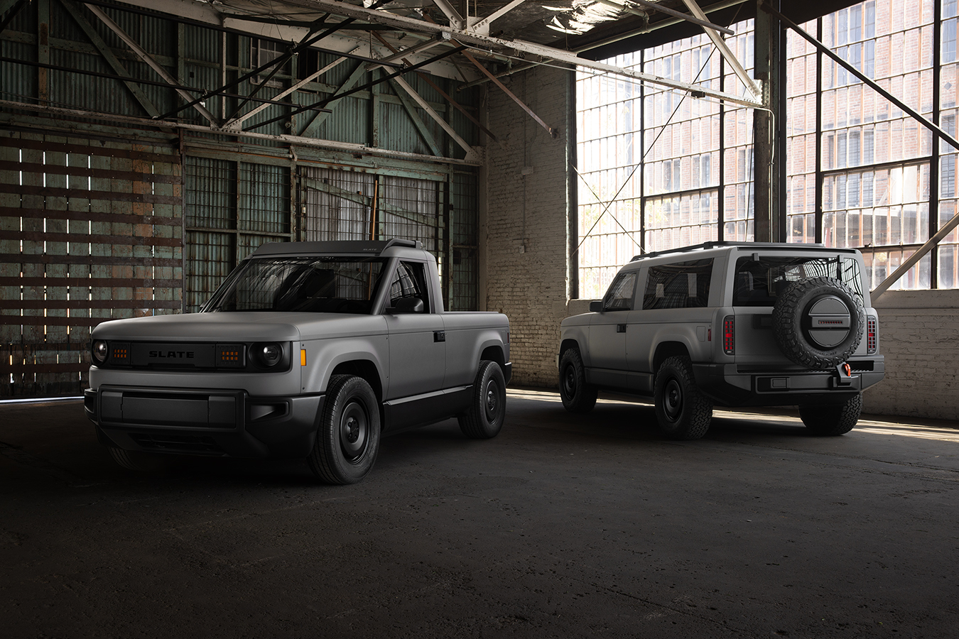 Pictures of two versions of the new Slate Auto pickup truck and SUV in a warehouse.
