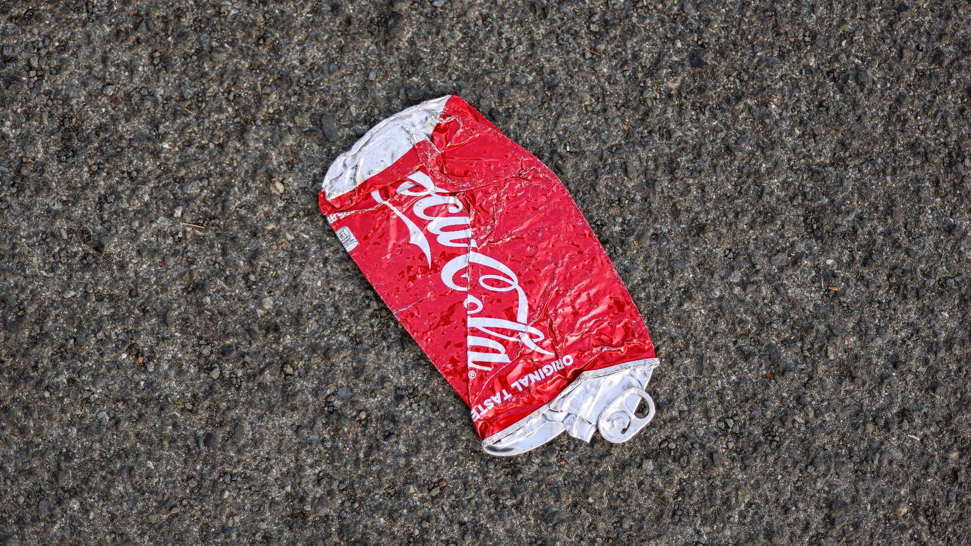 A crushed empty Coca-Cola can.