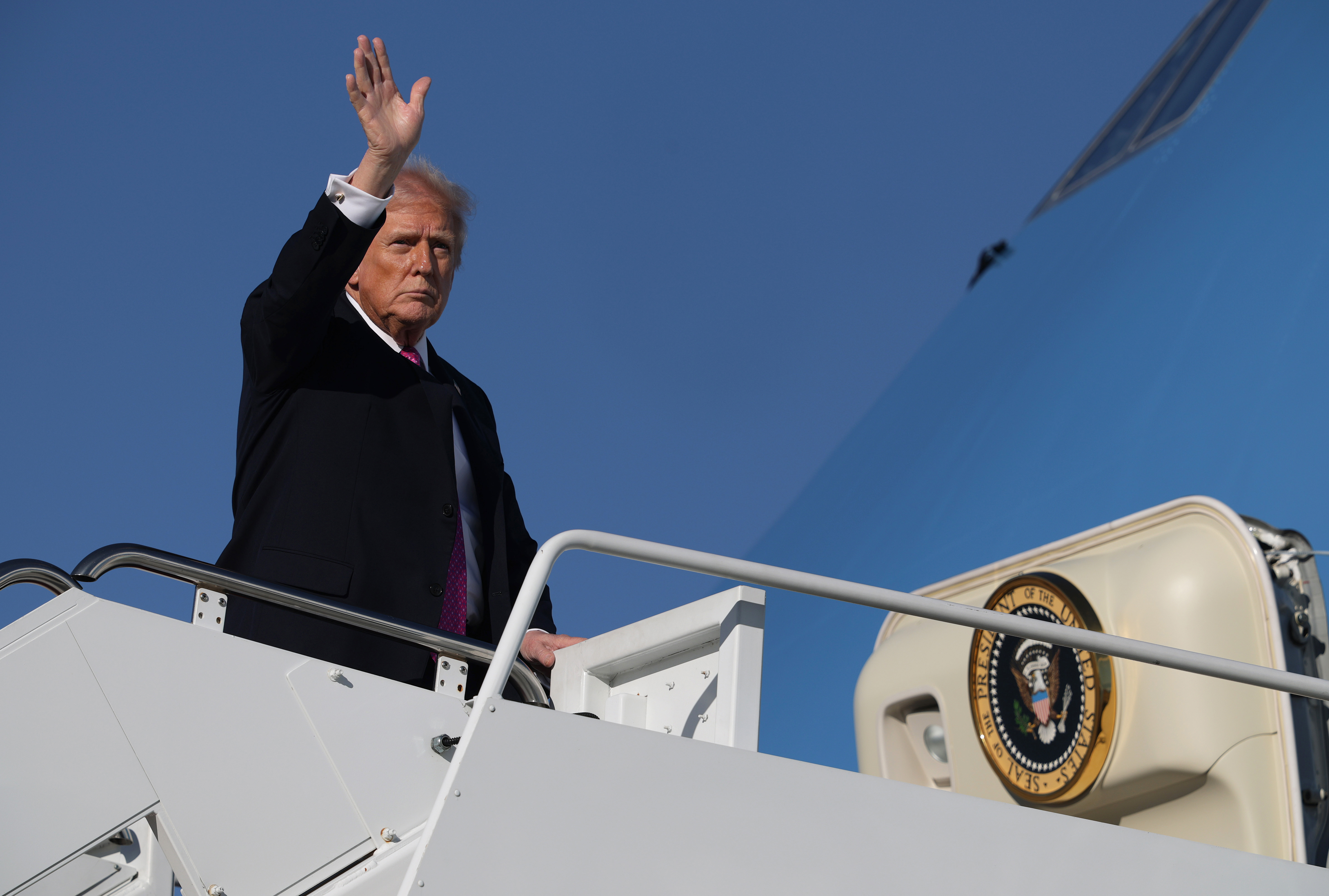 JOINT BASE ANDREWS, MARYLAND - OCTOBER 17: U. S. President Donald Trump waves as he boards Air Force One on October 17, 2025 at Joint Base Andrews in Maryland. President Trump is spending his weekend at Mar-a-Lago in Palm Beach, Florida. (Photo by Alex Wong/Getty Images)