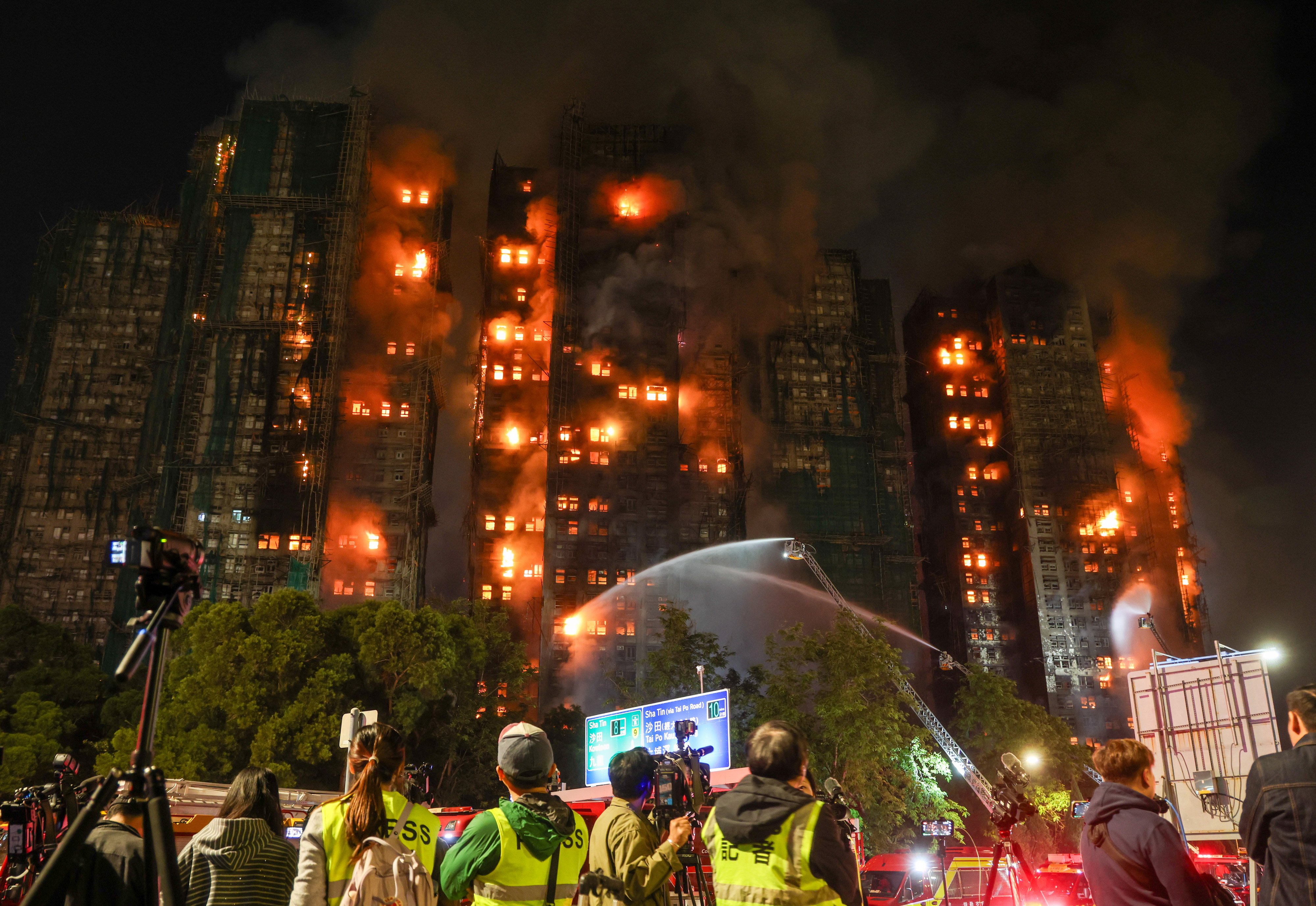 Firefighters tackle a fire engulfing residential buildings at Wang Fuk Court in the Tai Po district of Hong Kong, China, on Wednesday, Nov. 26, 2025. A major fire has engulfed an eight-tower, high-rise complex in Hong Kong, killing at least 13 people. Photographer: Yik Yeung-man/Bloomberg via Getty Images
