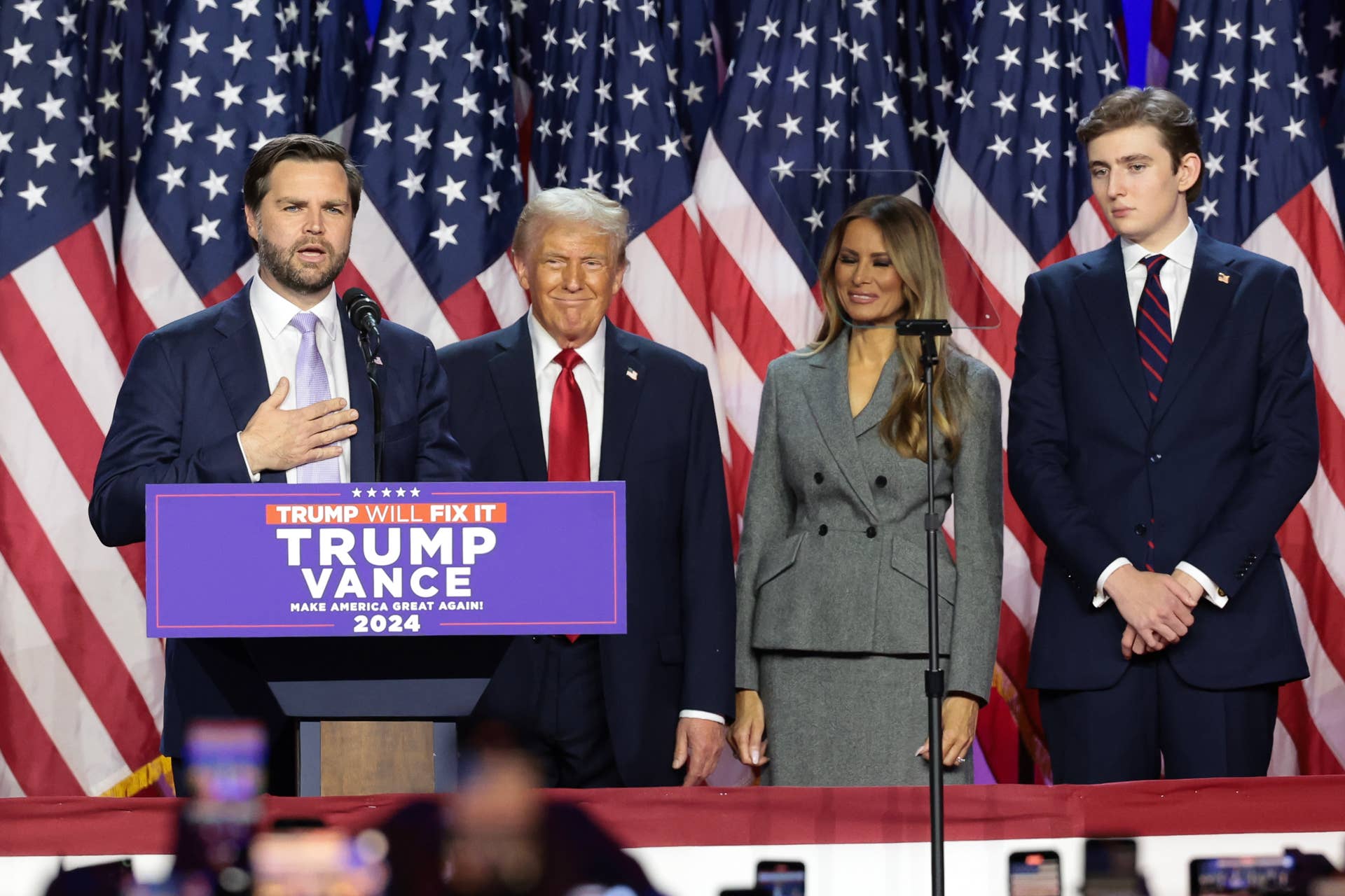 WEST PALM BEACH, FLORIDA - NOVEMBER 06: Republican vice presidential nominee, U.S. Sen. J.D. Vance (R-OH) speaks as Republican presidential nominee, former U.S. President Donald Trump, former first lady Melania Trump and Barron Trump look on during an election night event at the Palm Beach Convention Center on November 06, 2024 in West Palm Beach, Florida. Americans cast their ballots today in the presidential race between Republican nominee former President Donald Trump and Vice President Kamala Harris, as well as multiple state elections that will determine the balance of power in Congress. (Photo by Win McNamee/Getty Images)