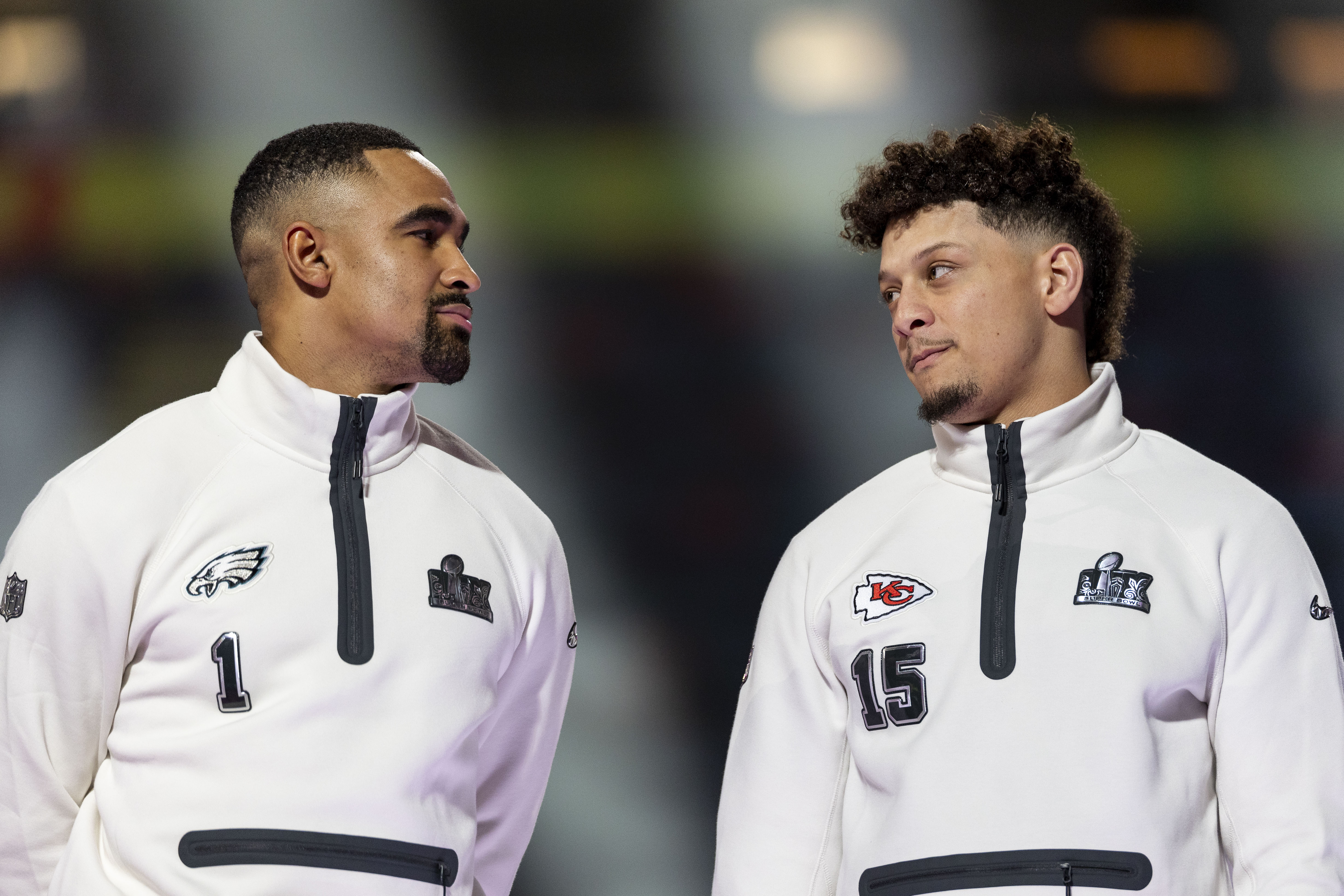 NEW ORLEANS, LOUISIANA - FEBRUARY 03: Jalen Hurts #1 of the Philadelphia Eagles and Patrick Mahomes #15 of the Kansas City Chiefs chat on stage during Super Bowl LIX Opening Night at Caesars Superdome on February 03, 2025 in New Orleans, Louisiana. (Photo by Michael Owens/Getty Images)